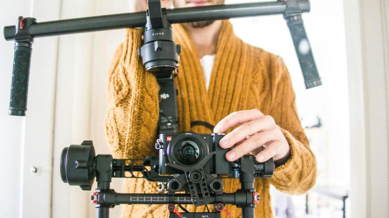 Content creator using professional camera equipment to film high-quality videos for OnlyFans and the adult industry