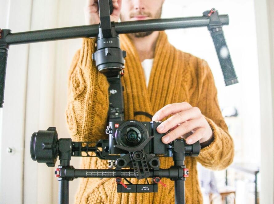 Content creator using professional camera equipment to film high-quality videos for OnlyFans and the adult industry