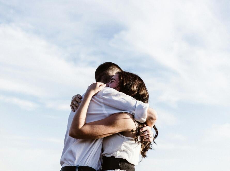 Couple hugging while discussing STD testing in a healthy relationship. Learn how to talk to your partner about STD testing with confidence and care.