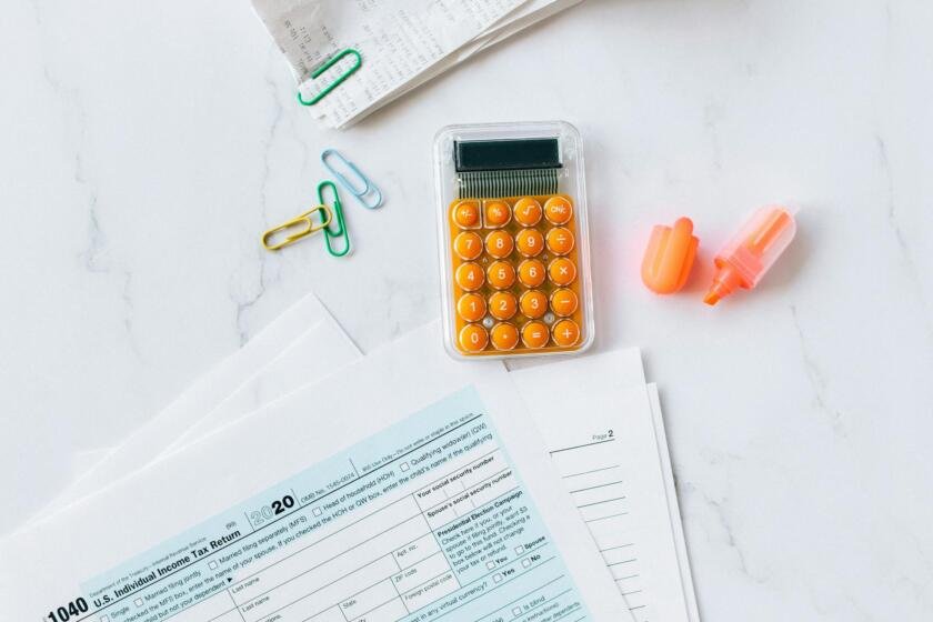 Desk overhead view with tax documents, calculator, and pen illustrating onlyfans taxes for content creators