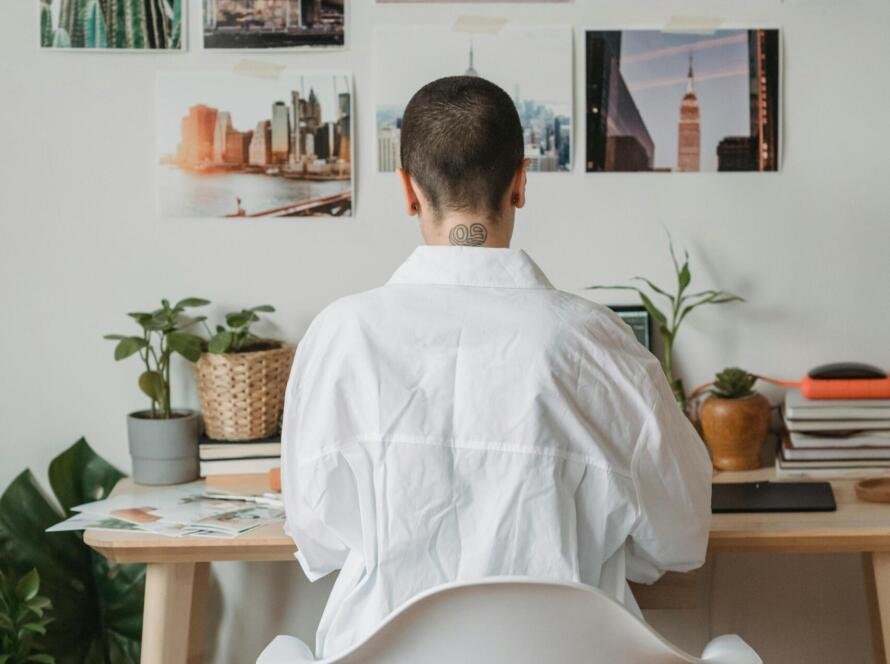 Adult content creator setting up an OnlyFans account on a laptop in a home office