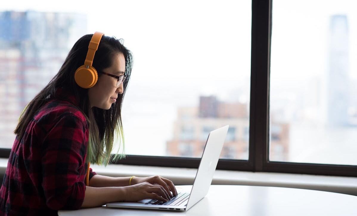 Adult content creator reading about the TAKE IT DOWN Act on a laptop